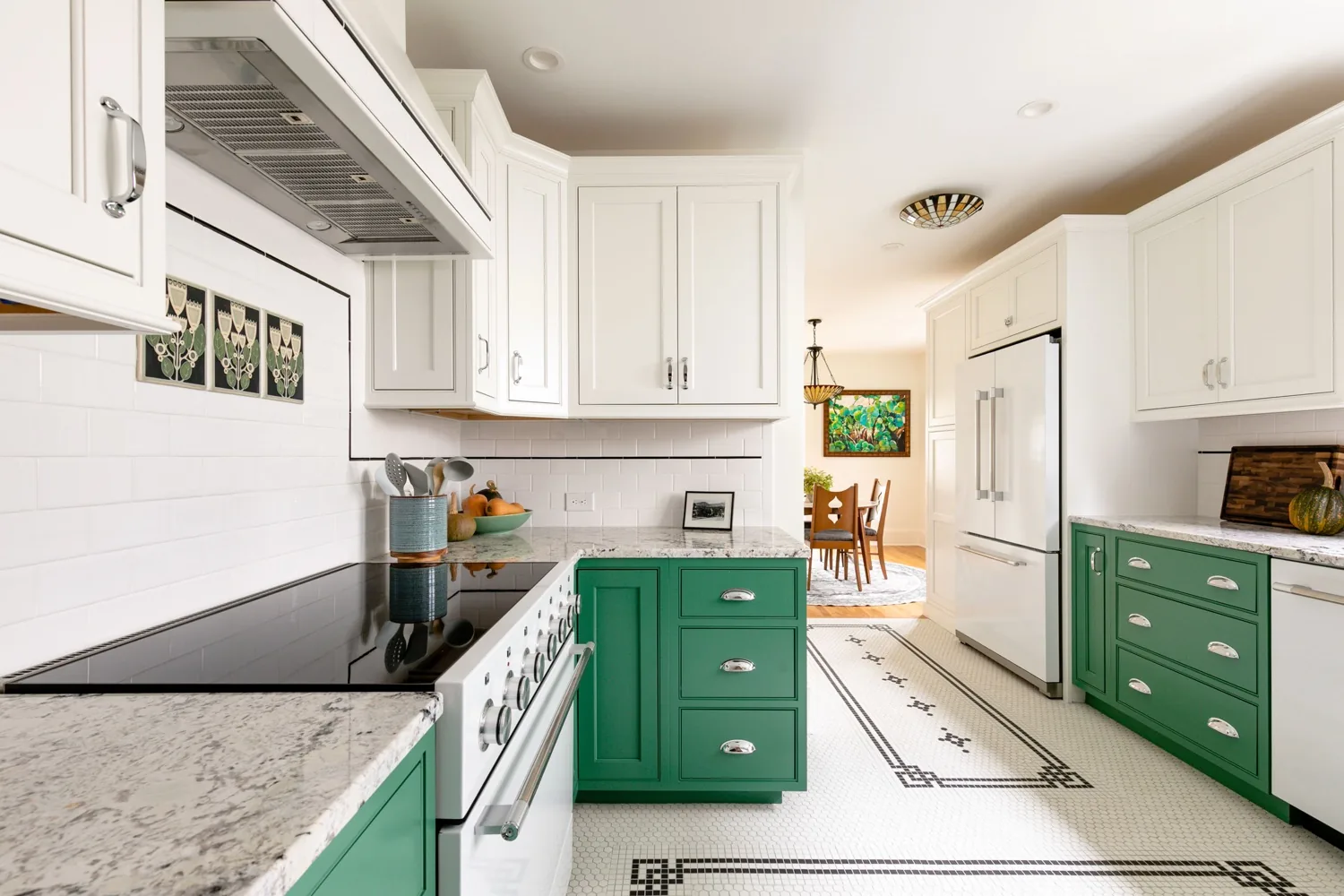 Kitchen with white upper cabinets, green lower cabinets and a patterned tile floor